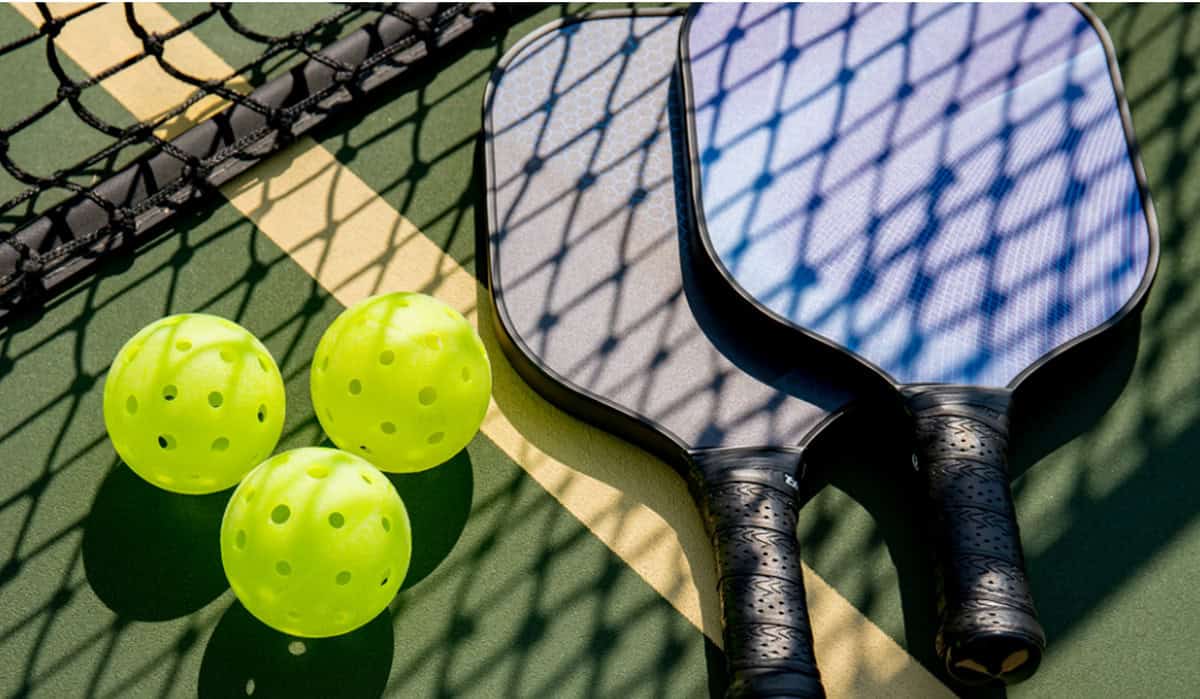 pickleball net with paddles and balls